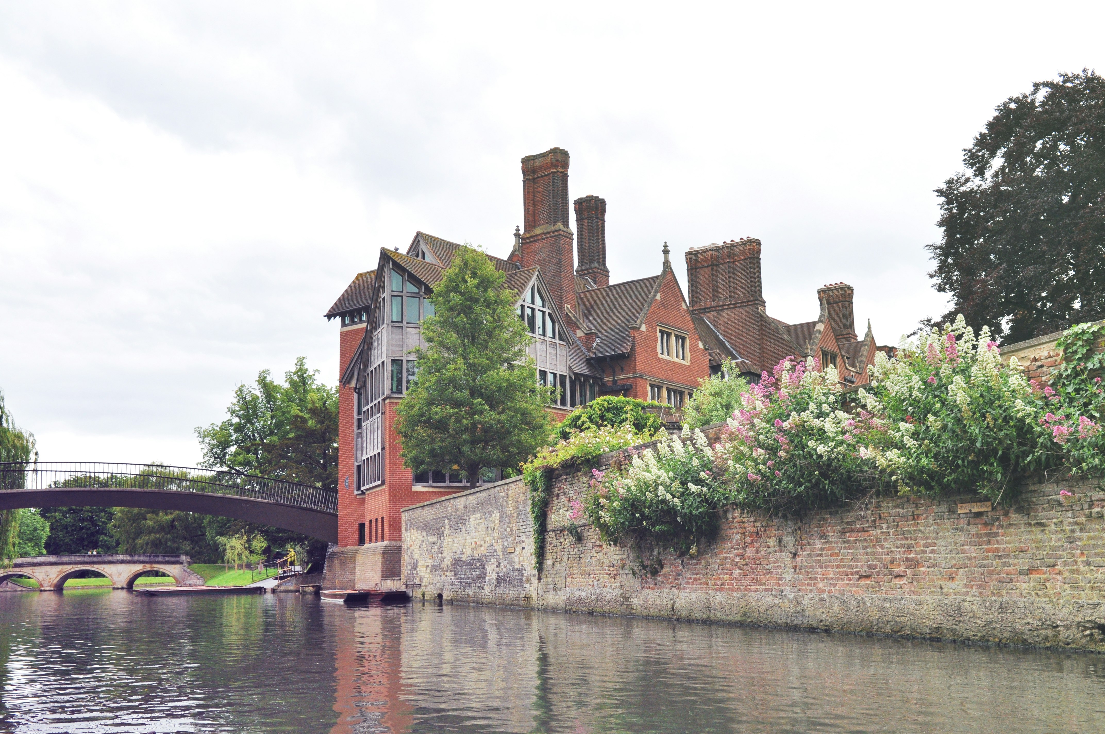 brown concrete building beside river during daytime